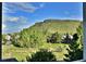 Expansive mountain views and lush landscaping create a serene and picturesque setting at 5932 Eldora St, Golden, CO 80403