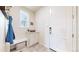 Mudroom area with bench, coat rack, and convenient access to the front door at 5932 Eldora St, Golden, CO 80403