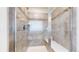 Elegant walk-in shower with tiled walls and a built-in bench, providing a modern and comfortable bathing experience at 5932 Eldora St, Golden, CO 80403