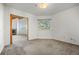 This carpeted bedroom features white walls and a doorway to another room in the home at 31819 Rocky Village Dr # 301, Evergreen, CO 80439