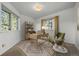 Sunny bedroom that could be a home office with large windows and neutral decor at 31819 Rocky Village Dr # 301, Evergreen, CO 80439