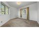 This carpeted bedroom features white walls and two large windows looking out onto the forest at 31819 Rocky Village Dr # 301, Evergreen, CO 80439