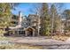 Exterior shot of a mountain-style building with stone accents and a prominent entrance at 31819 Rocky Village Dr # 301, Evergreen, CO 80439