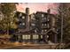 Luxury condo building featuring multiple balconies, stone accents and mountain views at 31819 Rocky Village Dr # 301, Evergreen, CO 80439