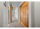 Hallway with wood-look closet doors and a view into the main living space at 31819 Rocky Village Dr # 301, Evergreen, CO 80439