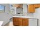 Kitchen with light cabinets, tiled backsplash, and a view to the living room at 31819 Rocky Village Dr # 301, Evergreen, CO 80439