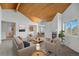 Bright living room with vaulted wood ceilings, large windows, and modern furniture at 31819 Rocky Village Dr # 301, Evergreen, CO 80439