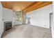 Spacious living room with vaulted wood ceilings, a cozy fireplace, and ample natural light at 31819 Rocky Village Dr # 301, Evergreen, CO 80439