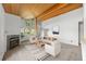 Open living area with wood-beam ceiling, fireplace, and lots of natural light at 31819 Rocky Village Dr # 301, Evergreen, CO 80439