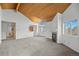 Bright living room features vaulted wood ceilings, fireplace, and large windows with scenic views at 31819 Rocky Village Dr # 301, Evergreen, CO 80439