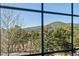 Scenic view of lush green trees and mountain range through a window at 31819 Rocky Village Dr # 301, Evergreen, CO 80439