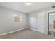 Neutral-toned bedroom featuring carpeted floors, a window, gray walls, a white door and trim, offering a calming ambiance at 1085 Victor St, Aurora, CO 80011