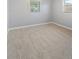 A bright empty bedroom with gray walls, carpeted floors, white trim and window frames, offering a blank canvas at 1085 Victor St, Aurora, CO 80011