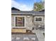 Stone exterior showcasing front entry with planter box and a small seating area on the front lawn at 1085 Victor St, Aurora, CO 80011