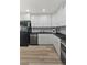 Modern kitchen featuring stainless steel appliances, black countertops, and sleek white cabinets at 1085 Victor St, Aurora, CO 80011