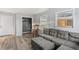 Living room features a gray sectional sofa, ottoman, and wood-look flooring plus a closet at 1085 Victor St, Aurora, CO 80011