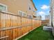 A view of a backyard with an artificial lawn and a wood fence at 13754 Ash Cir, Thornton, CO 80602