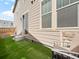 View of the back of the house with artificial grass and space for entertaining at 13754 Ash Cir, Thornton, CO 80602