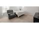 Carpeted bedroom featuring a comfortable chair, bed, and television at 13754 Ash Cir, Thornton, CO 80602