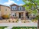 Charming townhome featuring stone accents and a well-manicured front yard at 13754 Ash Cir, Thornton, CO 80602
