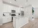 Bright kitchen features white cabinets, granite countertops, stainless steel appliances, and a kitchen island with pendant lighting at 13754 Ash Cir, Thornton, CO 80602