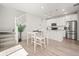 Bright kitchen and dining area with stainless steel appliances and modern finishes at 13754 Ash Cir, Thornton, CO 80602