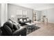 Modern living room features stylish sofas, geometric rug, and bright natural light at 13754 Ash Cir, Thornton, CO 80602