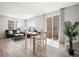 Bright living and dining area with sliding door access and stylish, modern furniture at 13754 Ash Cir, Thornton, CO 80602