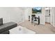 Neutral loft area includes a gray sectional, a desk, and access to a bathroom with a double vanity at 13754 Ash Cir, Thornton, CO 80602