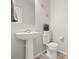 Clean powder room with a pedestal sink, toilet, and minimalist decorations at 13754 Ash Cir, Thornton, CO 80602