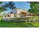 Beautiful backyard with lush grass, a patio, mature trees, and a wood fence surrounding the yard at 15122 Fillmore Way, Thornton, CO 80602