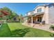 Spacious backyard with well-manicured lawn, a covered patio, and a view of the surrounding greenery at 15122 Fillmore Way, Thornton, CO 80602