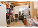 Unfinished basement with storage shelving and a window, great for organization and potential expansion at 15122 Fillmore Way, Thornton, CO 80602