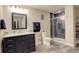 Modern bathroom with a marble-top vanity and walk-in shower with blue subway tile accents at 15122 Fillmore Way, Thornton, CO 80602