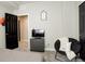 This bedroom has gray walls, black doors, a black papasan chair with a decorative pillow, and neutral carpet at 15122 Fillmore Way, Thornton, CO 80602