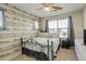 Inviting bedroom with a decorative wall design, comfortable bed, and plenty of natural light at 15122 Fillmore Way, Thornton, CO 80602