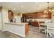 Bright kitchen boasts granite countertops, stainless steel appliances, and an adjacent breakfast nook with chandelier at 15122 Fillmore Way, Thornton, CO 80602