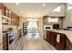 Open concept kitchen and dining area offer a fireplace, modern appliances, and plentiful natural light at 15122 Fillmore Way, Thornton, CO 80602