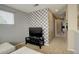 Bright living space with unique accent wall, neutral walls, neutral carpet, and a black media center with TV at 15122 Fillmore Way, Thornton, CO 80602