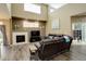 Spacious living room with a fireplace, high ceilings, and hardwood floors, perfect for gatherings at 15122 Fillmore Way, Thornton, CO 80602
