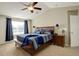 This main bedroom is bright with natural light, neutral walls, vaulted ceilings, a ceiling fan, and carpet at 15122 Fillmore Way, Thornton, CO 80602