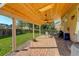 A covered outdoor patio with brick flooring, ceiling fans, and seating perfect for relaxation at 15122 Fillmore Way, Thornton, CO 80602