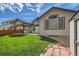 Well-maintained backyard with a lush lawn, patio, and garden shed at 15901 W 66Th Pl, Arvada, CO 80007