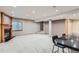 Spacious basement with bar seating, fireplace and adjacent staircase at 15901 W 66Th Pl, Arvada, CO 80007