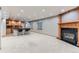 Basement showcasing a fireplace, carpet, bar seating, and kitchenette at 15901 W 66Th Pl, Arvada, CO 80007