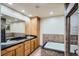 Bathroom features double sink vanity, soaking tub, and tiled shower at 15901 W 66Th Pl, Arvada, CO 80007