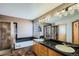 Bright bathroom featuring a tub, shower, double sink vanity and natural light at 15901 W 66Th Pl, Arvada, CO 80007