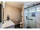Modern bathroom showcasing a sleek shower with glass doors, and elegant fixtures at 15901 W 66Th Pl, Arvada, CO 80007
