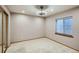 Carpeted bedroom features closet, window, ceiling fan, and neutral colored walls at 15901 W 66Th Pl, Arvada, CO 80007