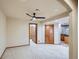 Bedroom features carpet, neutral walls, ceiling fan and access to other rooms at 15901 W 66Th Pl, Arvada, CO 80007